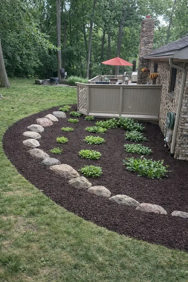 Mulch and rock bordered garden beds at a Parker Lawn & Landscape job in Oakland County, MI
